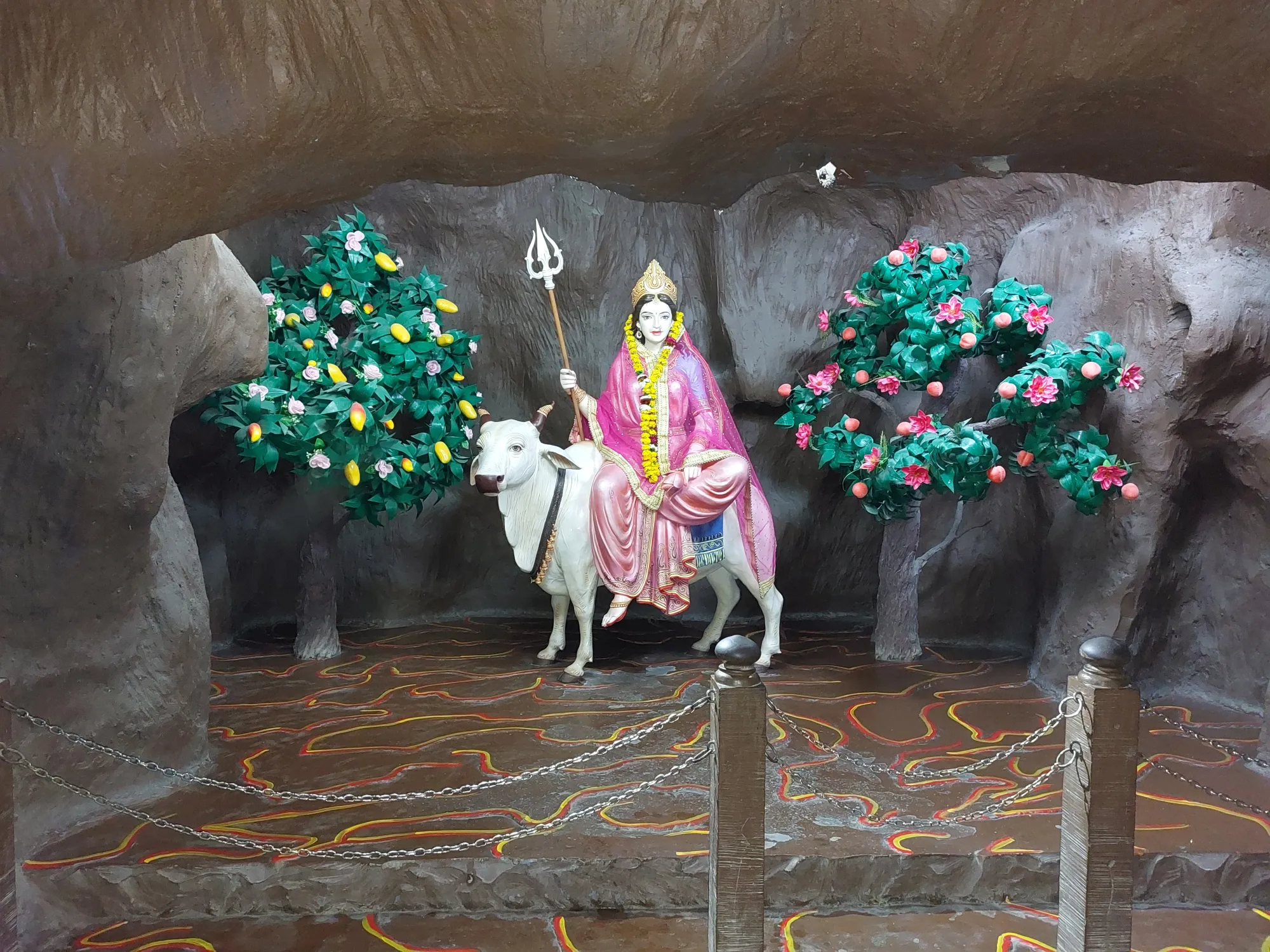 a statue of a goddess Shailaputri, First Navratri Devi with arms and a Cow in a cave