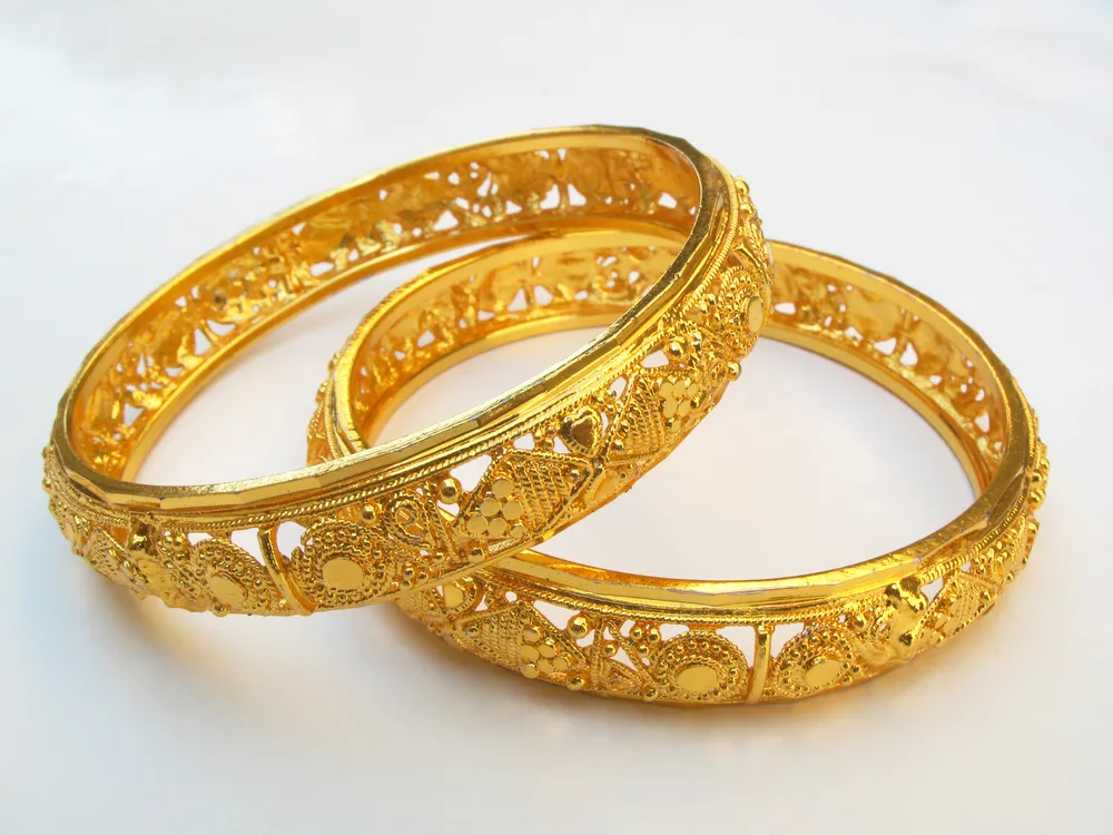 Opt for designer bangles with precious stones