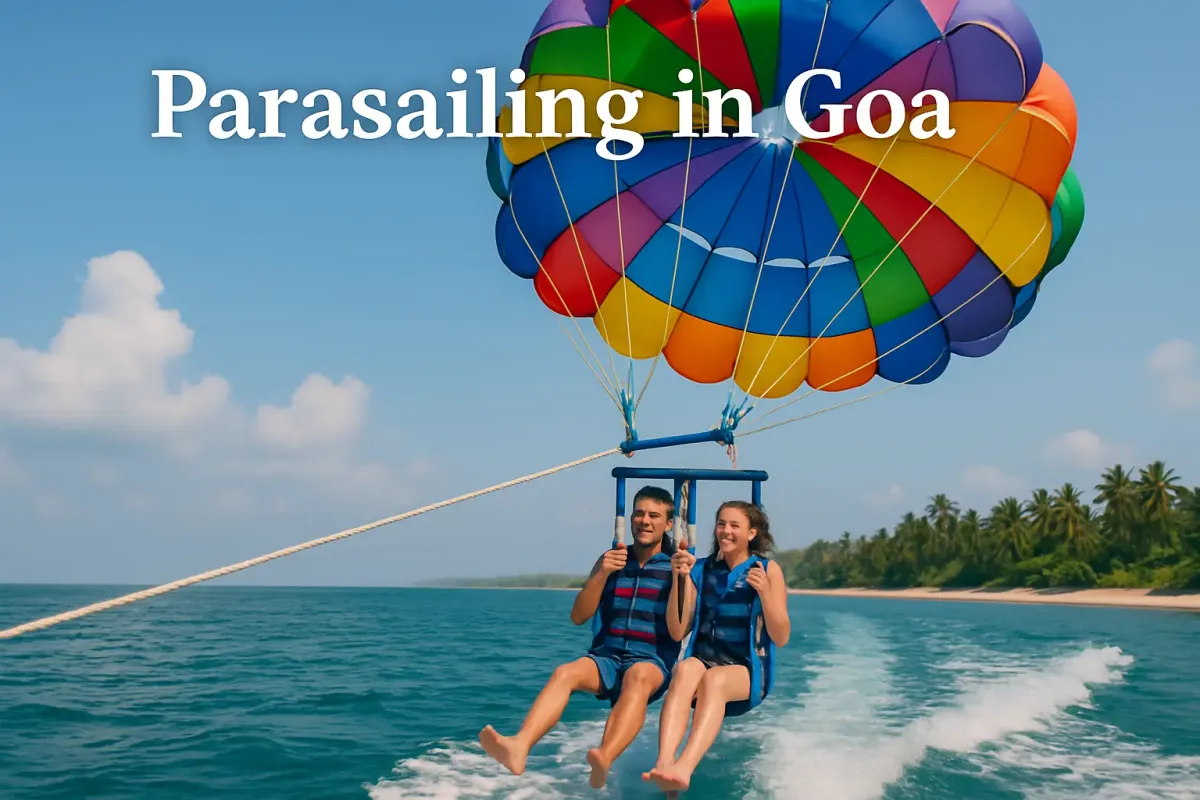 Couple parasailing over blue sea in Goa with colorful parachute and palm-lined beach in the background.