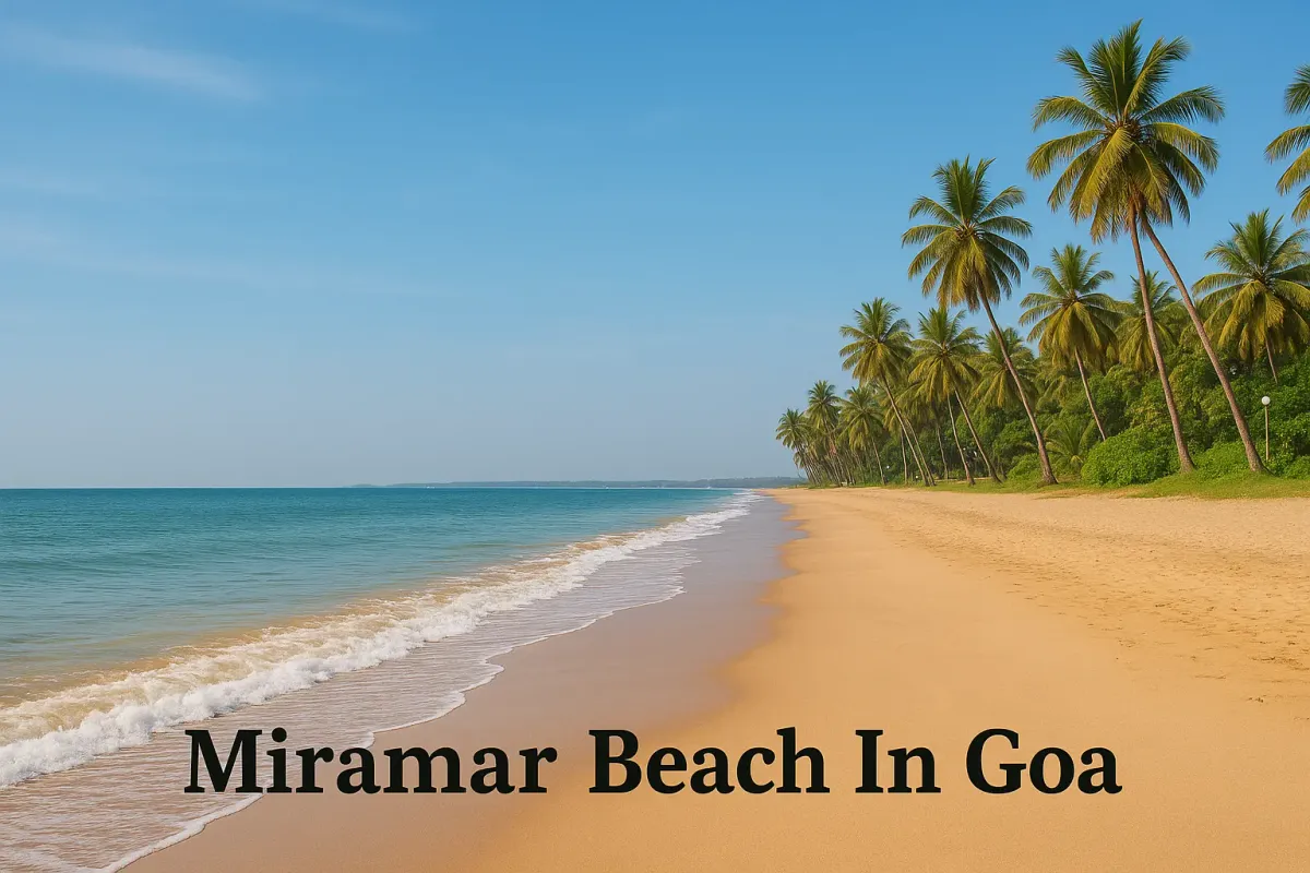 Golden sand and palm trees along Miramar Beach in Goa with calm sea waves and clear blue sky.